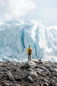 A man posing on the ice formation of the Perito Moreno glacier, Argentina