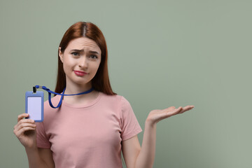 Disappointed woman with vip pass badge on pale green background. Space for text