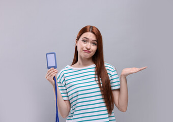Fototapeta premium Disappointed woman with vip pass badge on light grey background