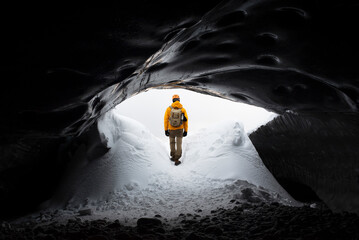  traveler finds himself detained in an impressive landscape of ice inside the Vatnajokull National Park, in Iceland. The dazzling ice formations and intricate patterns reveal the magnificent beauty o