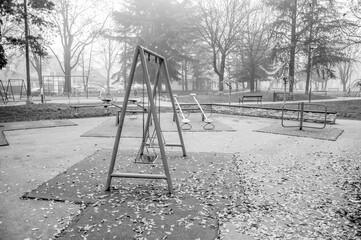 Black & White Moody Photo of an Empty Park on a Foggy Day with Trees in the Background