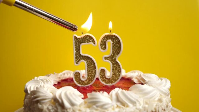 A candle in the form of the number 53 is lit, which is stuck into the holiday cake. Celebrating a birthday or a landmark event. The climax of the celebration.