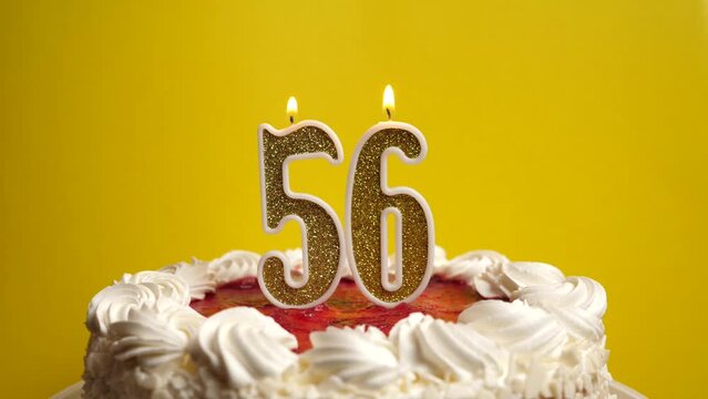 A candle in the form of the number 56 is lit, which is stuck into the holiday cake. Celebrating a birthday or a landmark event. The climax of the celebration.