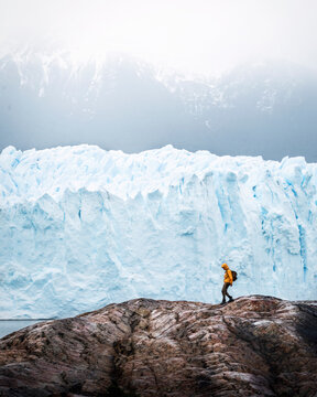 A man posing on the ice formation of the Perito Moreno glacier, Argentina