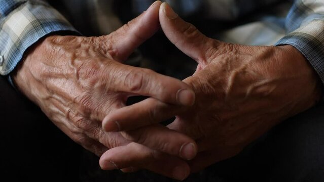 close-up wrinkled veiny hands of an elderly man crossed with fingers. pensioner in thought. elderly people concept.senior people theme