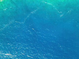 Aerial top down view of sea surface turquoise water