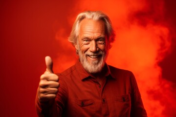 Medium shot portrait photography of a glad mature man raising both thumbs up against a fiery red background. With generative AI technology