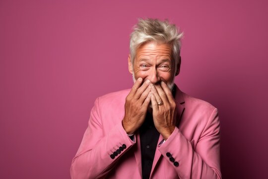 Medium shot portrait photography of a glad mature man making a surprise gesture by covering one's mouth against a hot pink background. With generative AI technology