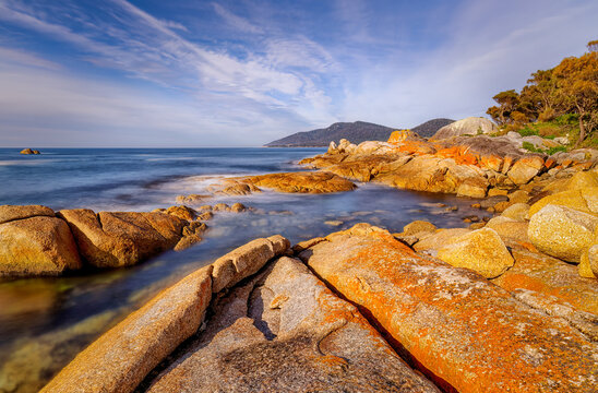 The beautiful lichen-covered rocks on the beach at Bicheno, Bay of Fires, Tasmania, Australia.