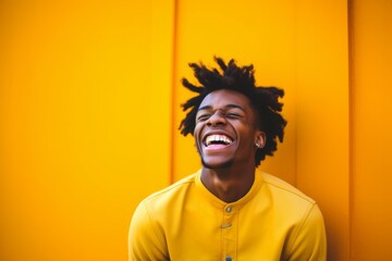 Medium shot portrait photography of a glad boy in his 20s laughing against a bright yellow background. With generative AI technology