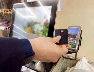 Customer pays his purchase at the supermarket,self checkout systems in  retail stores,Barcode scanner,Self checkout machine