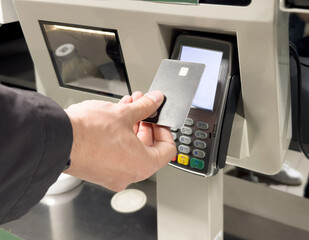 Customer pays his purchase at the supermarket,self checkout systems in  retail stores,Barcode scanner,Self checkout machine