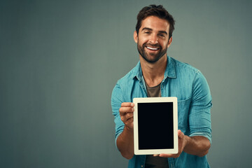 Happy man, tablet and advertising screen on mockup for marketing or branding against a grey studio...