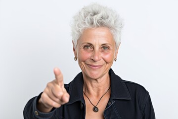 Headshot portrait photography of a satisfied mature woman making a i have an idea gesture with a finger up against a pearl white background. With generative AI technology