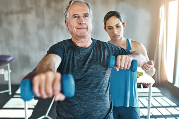 Physical therapy, dumbbell and support with old man and personal trainer for fitness, health and...