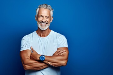 Medium shot portrait photography of a grinning mature man doing a yoga pose against a sapphire blue background. With generative AI technology