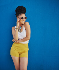 Sunglasses, fashion and portrait of woman on blue background, wall and summer streetwear, trendy clothes or shades mockup. Girl, happy and excited model with cool style, vision and urban mock up