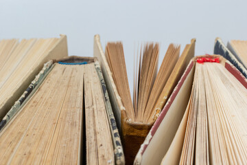 Book background. Stack of books in the library. Old yellow pages of paper books. Learning and knowledge