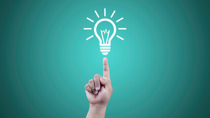 Bulb light on men Fingertip on green background.