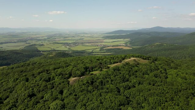 Aerial view of the forest covered hills of Zobor Mountain on a sunny day, 4k