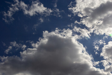 clouds in the sky lit by the sun on a summer day. background