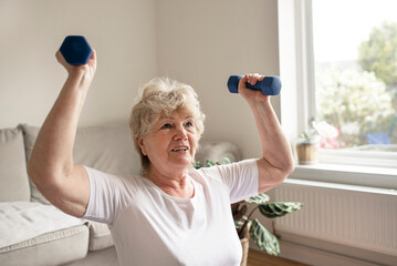 elderly woman exercising at home with weights