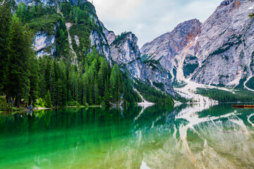 Fototapeta na wymiar Mountain blue lake water landscape. Braies lake with crystal water in background of mountains. Dolomites, Italy.