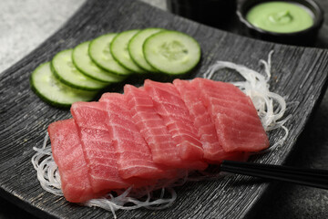Tasty sashimi (pieces of fresh raw tuna) and glass noodles on plate, closeup
