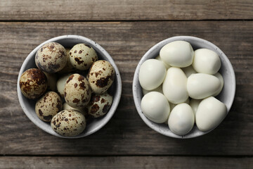 Unpeeled and peeled boiled quail eggs in bowls on wooden table, flat lay