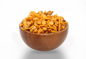 Hot spicy NavRatan snacks in wooden bowl, made with, potato chips, peanuts, besan sev, red chili.