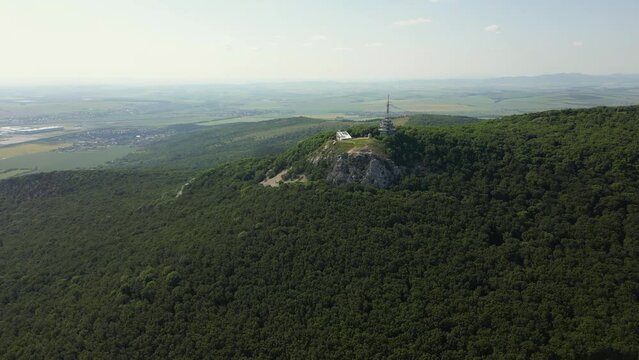 Drone is flying over the forest on the hill of the mountain, radio tower, 4k