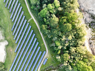 A large-scale solar farm set in a countryside environment