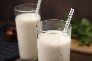 Glasses of delicious date smoothie on table, closeup