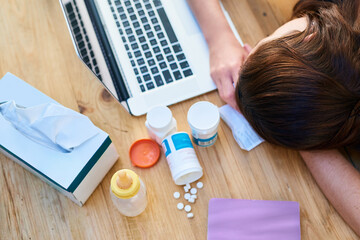 Top view, sick and woman with a laptop, sleeping and burnout with medicine, tired and career. Female person, professional or employee with medication, healthcare issue or problem with pills or tissue