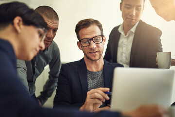 Laptop, business meeting and group of people with website launch, online reviews and results, profit or manager training. Presentation, design feedback and professional man and employees on computer