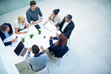 Top view, business people and staff in a meeting, feedback or conversation for report on a project,...
