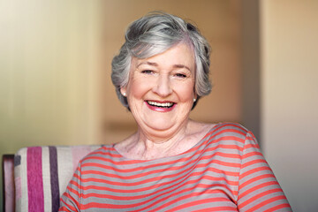 Portrait, happy and senior woman in nursing home, relax in living room or smile in retirement....