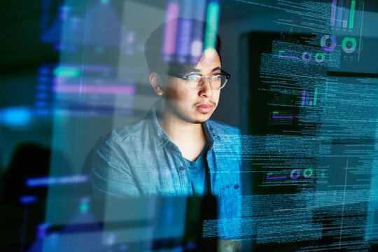 Night, code and hologram with man in office for programming, future and software development. Big data, networking and technology with male developer for cloud computing, programmer and coding