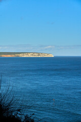 A vertically oriented photograph of Culver cliff on a summer day viewed from Shanklin on the Isle of Wight