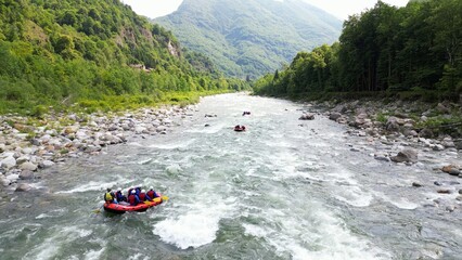 Go rafting on the river with dinghies immersed in the rapids of the stream and the nature of the...