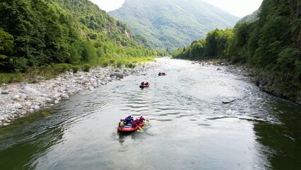 Go rafting on the river with dinghies immersed in the rapids of the stream and the nature of the...