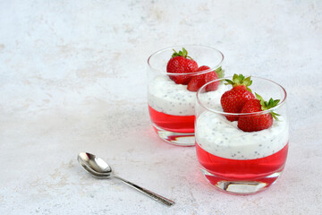healthy snack with chia pudding and strawberry in drinking glass, copy space 