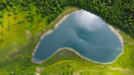 Beautiful lake on the mountain, aerial drone view. A lake surrounded by forest. Uloško or Crvanjsko jezero, Bosnia and Herzegovina.