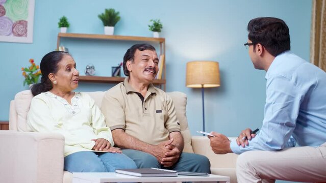 Happy smiling psychologist avising to senior couple during couseling at home - concept of consultation, mental illness and health care
