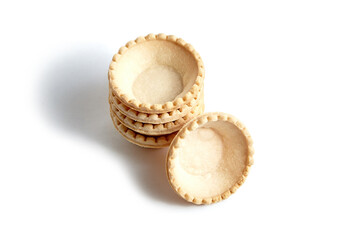 Tartlet shells isolated on white background. Stacked empty mini tart shells for portable desserts