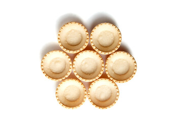 Tartlet shells isolated on white background, top view. Empty mini tart shells for portable desserts