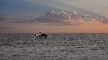 A fishing boat returning from the sea at sunset in Gokceada, Imbros island Canakkale, Turkey