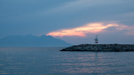 Sunset, Greek island Samothrace and lighthouse view at Gokceada Kalekoy location. Imbros island Canakkale, Turkey