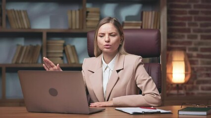 Ambitious company director conducting video conference on laptop with colleagues and denying all new ideas. Determined lady felling disappointed with employees underperformance.