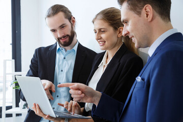 Business team working on master plan. Happy smiling businessman and businesswoman talking about success marketing plan after meeting and presenting to the manager.